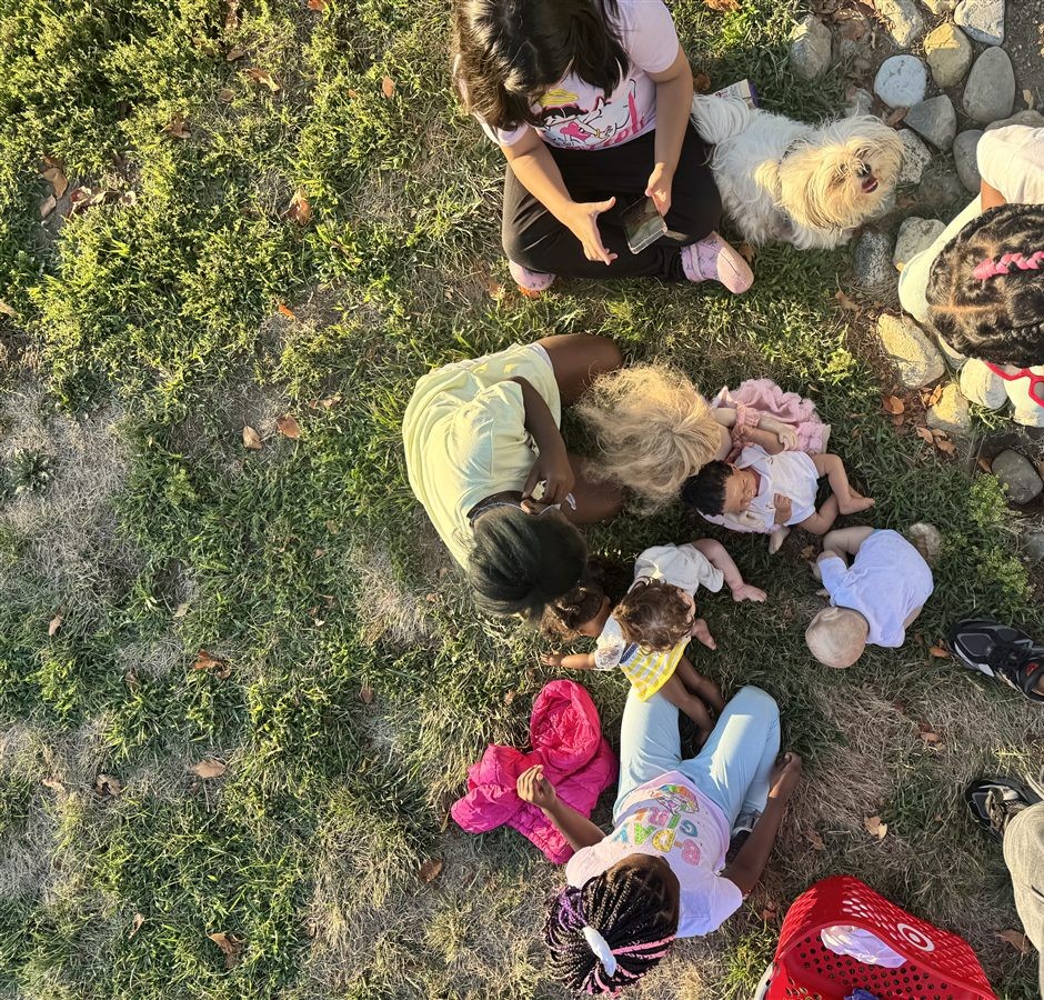 Children and families together at an outdoor community activity.